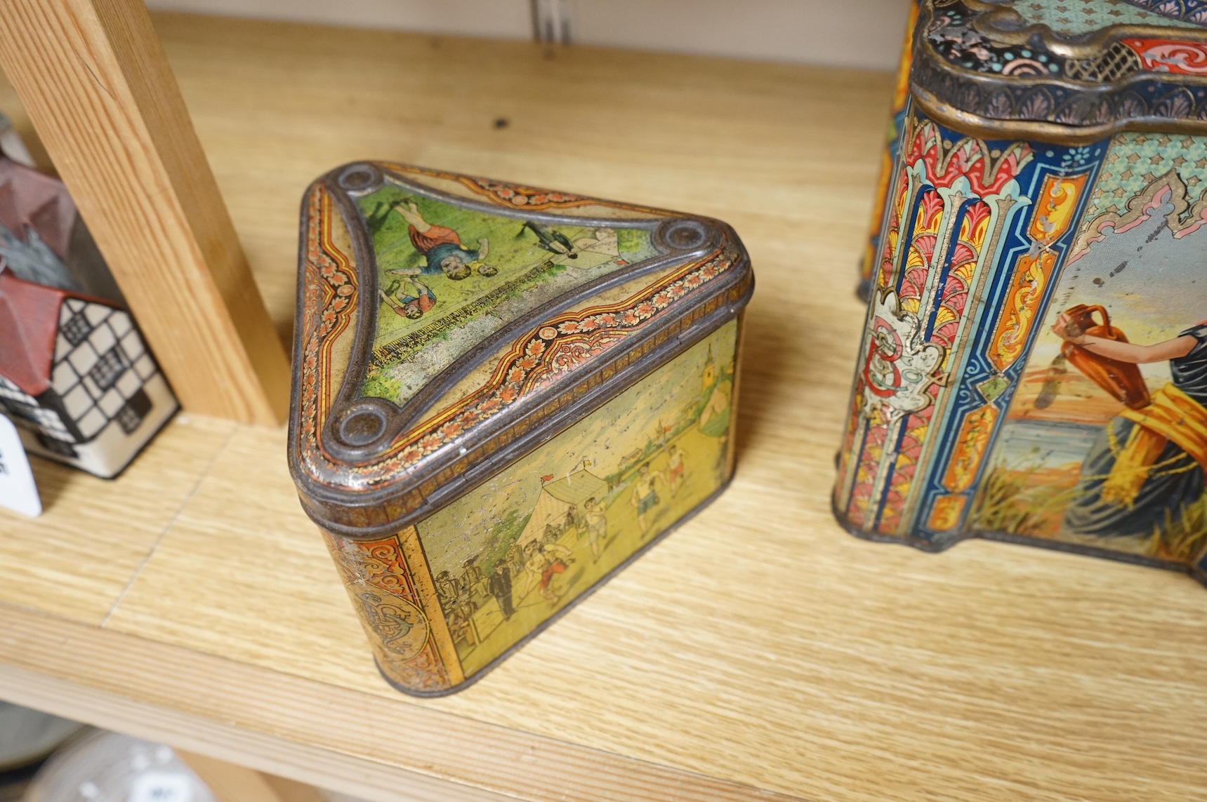 A Windmill biscuit tin by Huntley & Palmer: Reading & London, 'BIVM' Eastern Beauties tea tin and Huntley & Palmers triangular biscuit tin with 'Sports' motifs